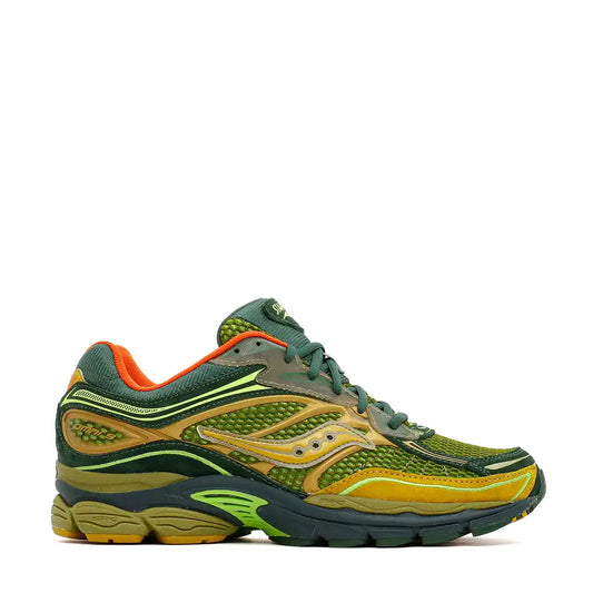 Athletic running shoe in green and gold colors with orange accents.