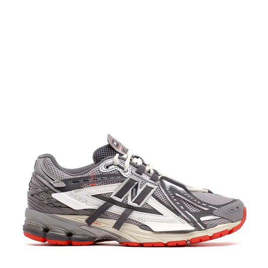 Athletic running shoe in grey, white, and red colors with mesh panels and cushioned sole.