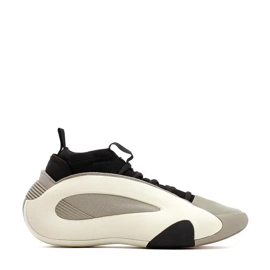 Athletic sneaker with a futuristic design featuring cream, gray and black color blocks.