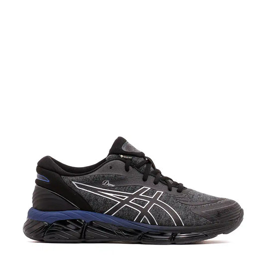 Black and gray ASICS athletic running shoe with blue accents.