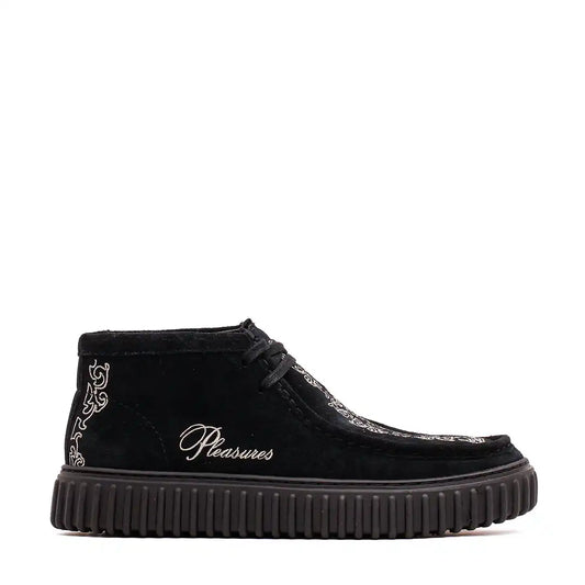 Black suede chukka boot with decorative embroidery and a ribbed platform sole.