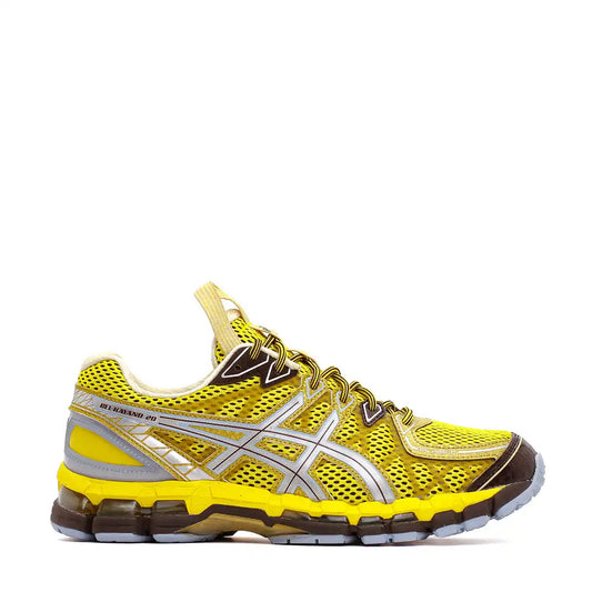 Yellow and silver ASICS running shoe with mesh panels and gel cushioning.